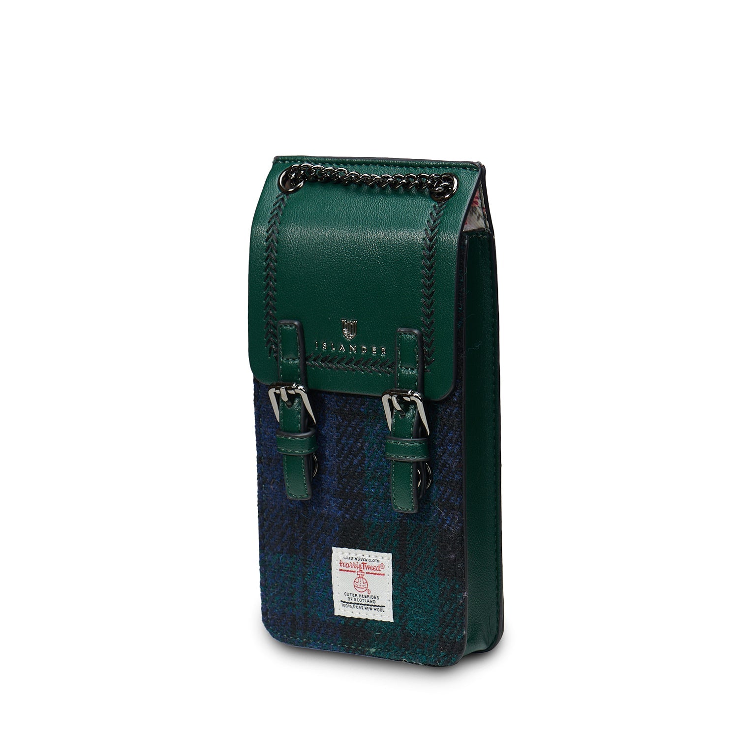 Green and blue plaid crossbody bag with chain strap on a textured surface