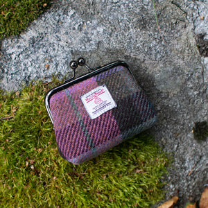 Small plaid pouch on a stone surface with a label