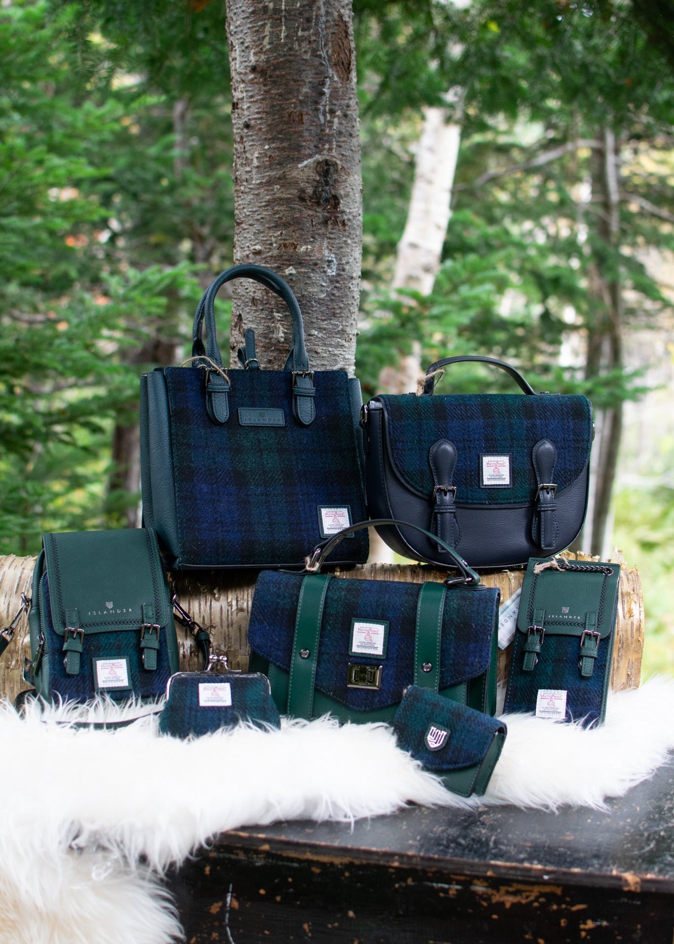 Collection of green and blue bags on a wooden surface with a natural background