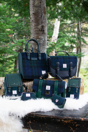 Collection of green and blue bags on a wooden surface with a natural background